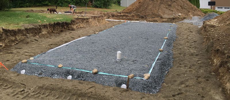 A concrete slab being poured for the foundation of a house.